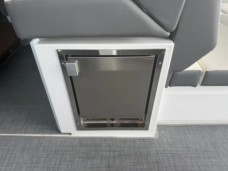 Slide: The Image of A small refrigerator is integrated into the seating area of a 2021 Cruisers Yachts 42 GLS OB. - 48