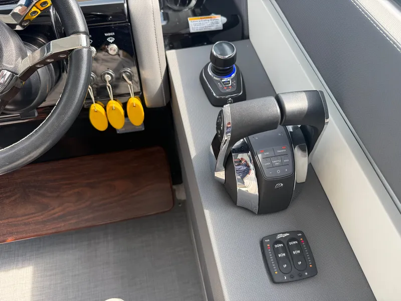 Slide: The Image of The image shows the helm of a 2021 Cruisers Yachts 42 GLS OB with modern controls. - 17