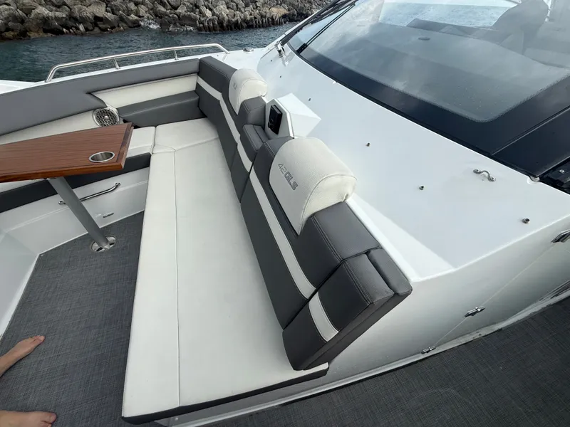 Slide: The Image of The 2021 Cruisers Yachts 42 GLS OB features an elegant bench with gray and white upholstery. - 22