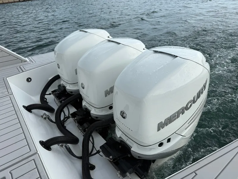 Slide: The Image of Three Mercury outboard engines on a 2021 Cruisers Yachts 42 GLS OB in calm water. - 40