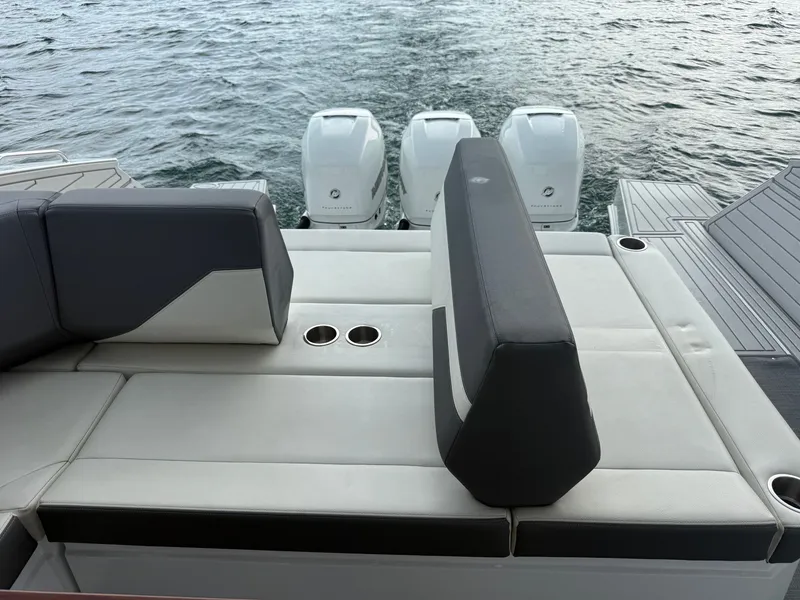 Slide: The Image of The image shows the stern of a 2021 Cruisers Yachts 42 GLS OB with three outboard engines. - 45