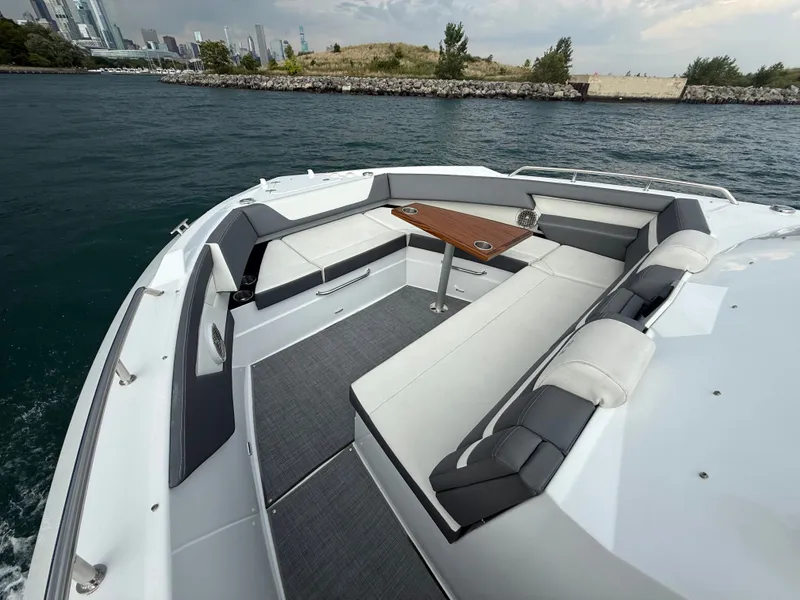 Slide: The Image of The image shows the bow of a 2021 Cruisers Yachts 42 GLS OB with sleek seating and a table. - 20
