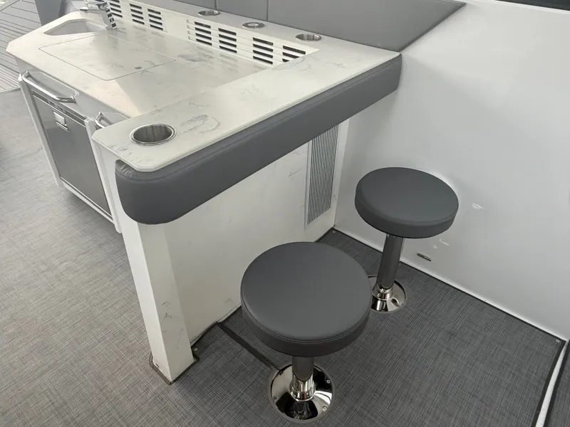 Slide: The Image of The 2021 Cruisers Yachts 42 GLS OB features a sleek bar area with two cushioned stools. - 46