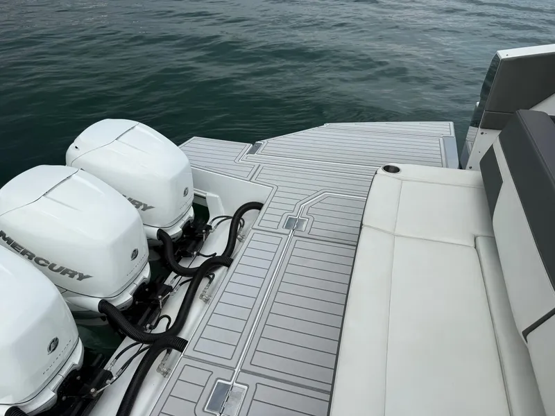 Slide: The Image of The image shows the stern of a 2021 Cruisers Yachts 42 GLS OB with three outboard engines. - 38