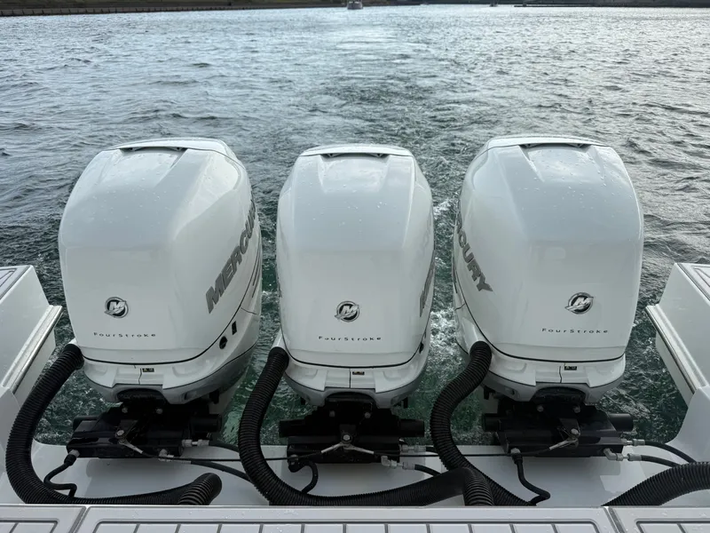 Slide: The Image of Three Mercury outboard engines on a boat in calm waters. - 41