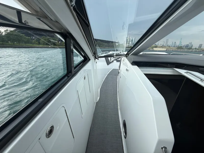 Slide: The Image of View of a modern yacht's side walkway with large windows and gray flooring. - 19