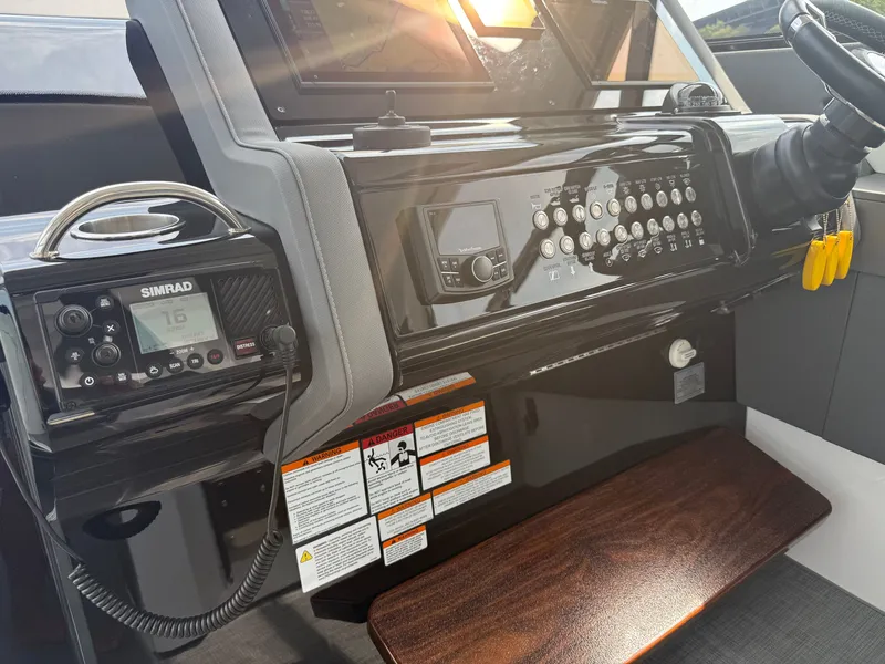 Slide: The Image of The image shows the helm of a 2021 Cruisers Yachts 42 GLS OB with modern instruments. - 16