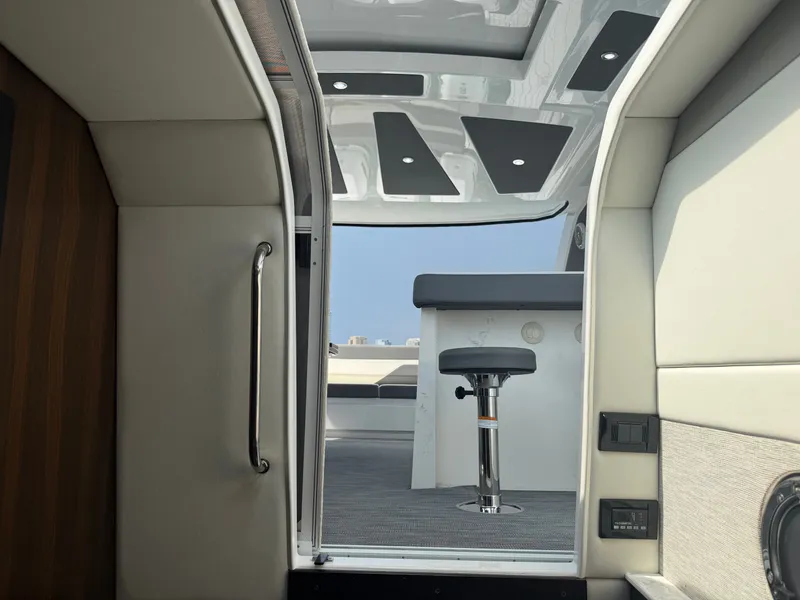 Slide: The Image of Interior view of a modern yacht with sleek seating and a large window. - 36