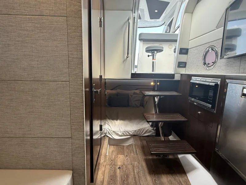 Slide: The Image of Interior of a 2021 Cruisers Yachts 42 GLS OB with cozy bed and wooden flooring. - 28