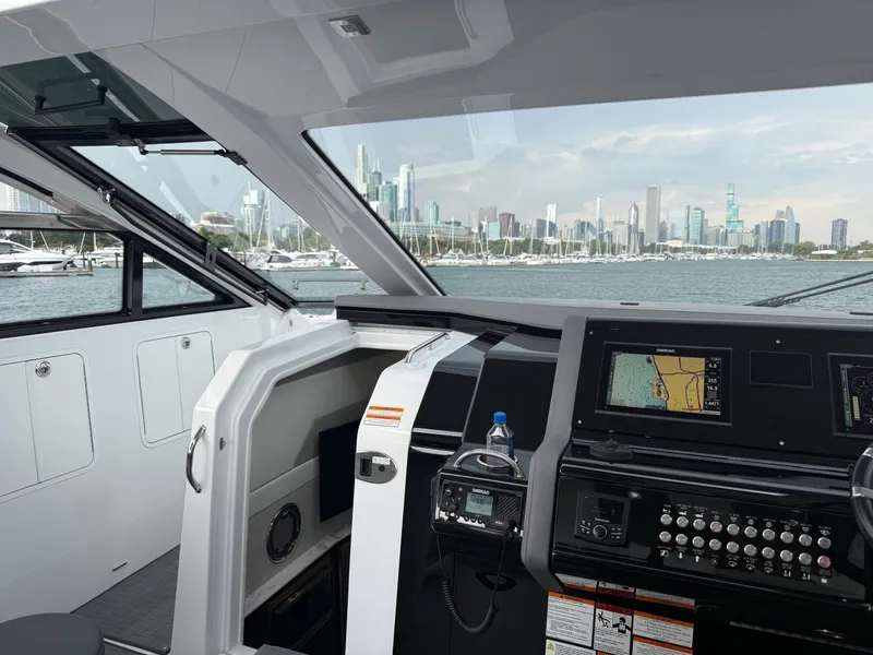 Slide: The Image of The cockpit of a 2021 Cruisers Yachts 42 GLS OB with a cityscape view. - 14