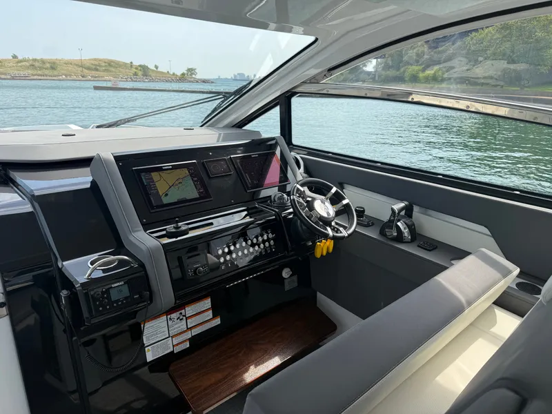 Slide: The Image of The 2021 Cruisers Yachts 42 GLS OB cockpit features a modern helm with electronic displays. - 15