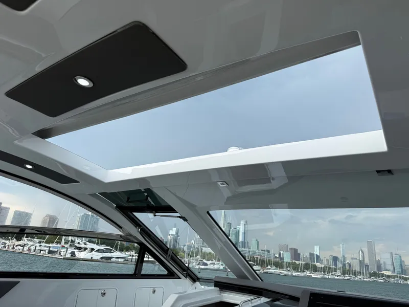Slide: The Image of Interior view of a modern yacht with a large panoramic roof and city skyline view. - 18