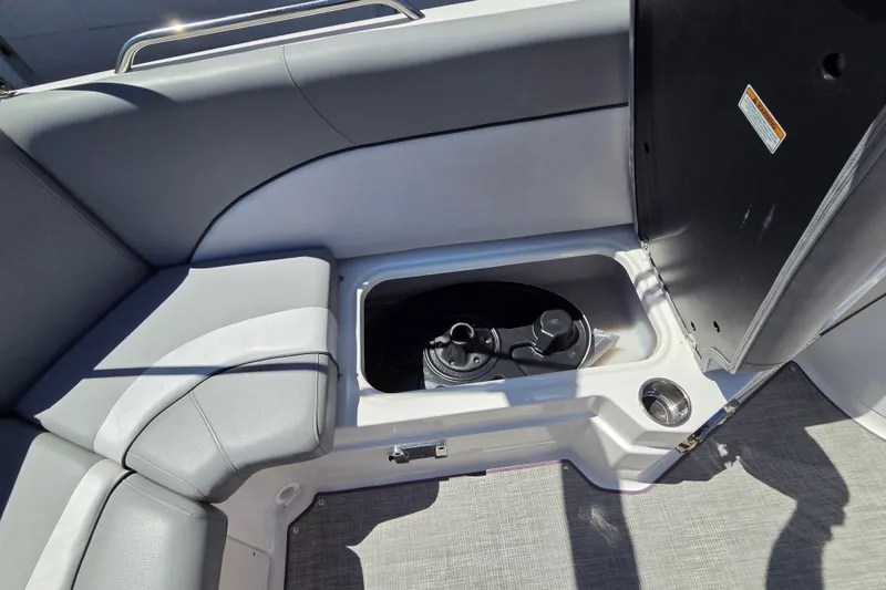 Slide: The Image of 2022 NauticStar 223 DC boat interior storage compartment with gray seating and cup holder. - 15