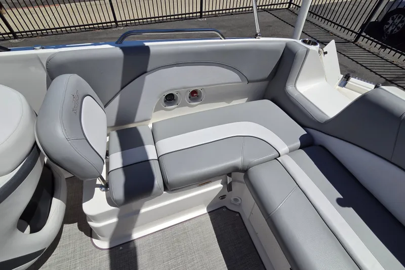 Slide: The Image of 2022 NauticStar 223 DC boat interior with gray and white seating, showcasing modern design. - 16