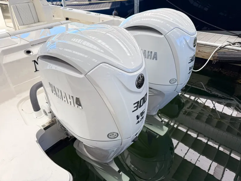 Slide: The Image of Two Yamaha 300 HP outboard engines on a Pursuit OS 325 Offshore boat in the water. - 14