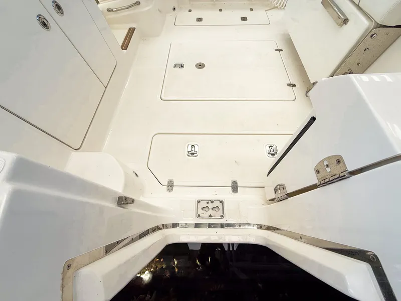 Slide: The Image of The image shows the cockpit of a Pursuit OS 325 Offshore boat with storage hatches. - 20
