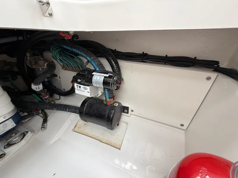 Slide: The Image of Close-up of the engine compartment in a Pursuit OS 325 Offshore, showing wiring and components. - 41