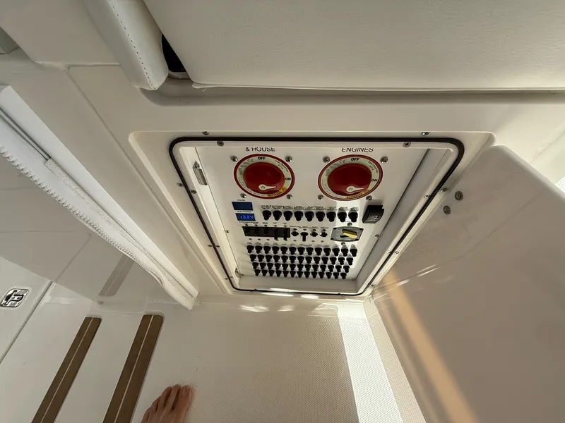 Slide: The Image of An electrical control panel on a boat with various switches and indicators. - 45