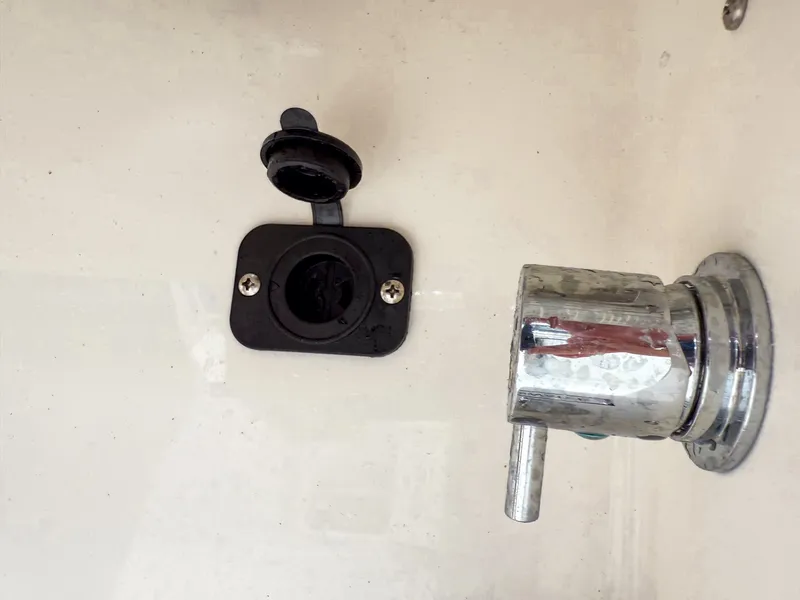 Slide: The Image of Close-up of a boat component with an outlet and a metal valve. - 25