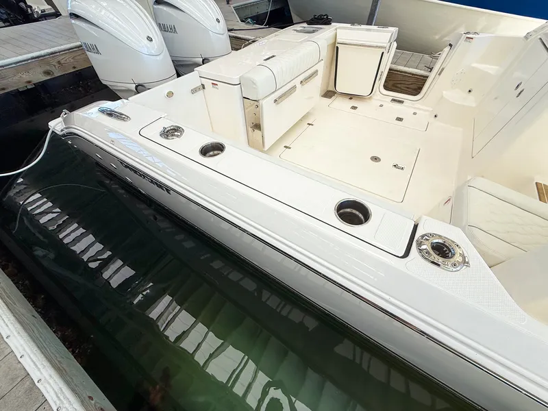 Slide: The Image of The image shows the deck of a 2026 Pursuit OS 325 Offshore boat with two engines. - 11