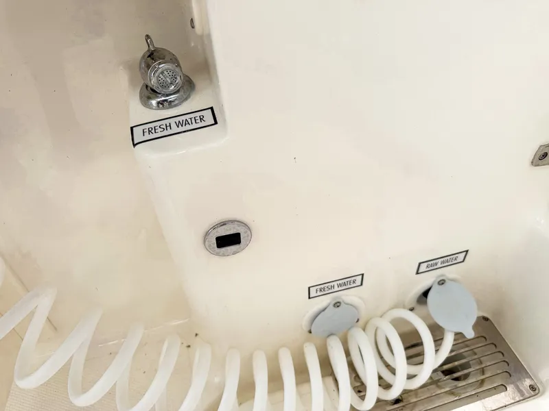 Slide: The Image of Close-up of a boat wash area with fresh water connection and coiled hose. - 26