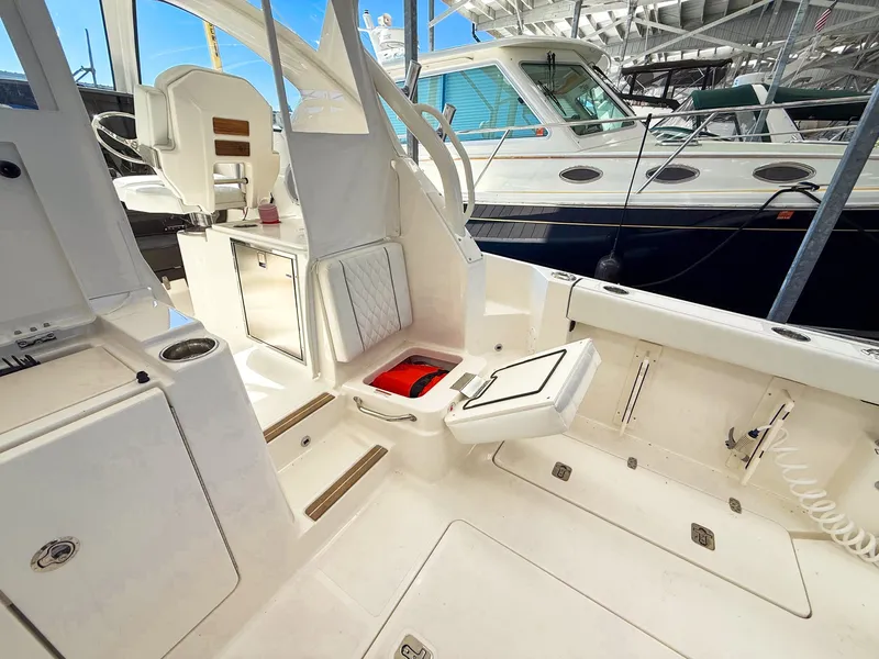 Slide: The Image of The image shows the cockpit of a 2026 Pursuit OS 325 Offshore. It is spacious and well-equipped. - 36