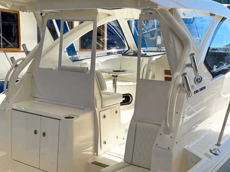 Slide: The Image of The image shows the cockpit of a 2026 Pursuit OS 325 Offshore with white upholstery and a table. - 7