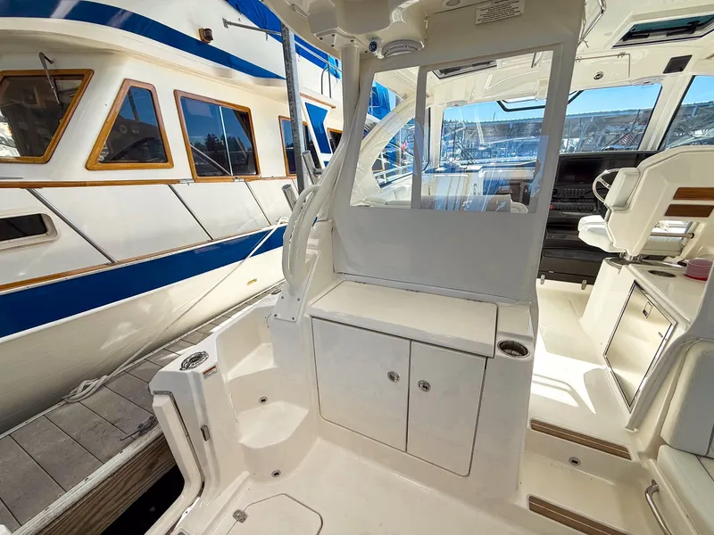 Slide: The Image of The image shows the cockpit of a 2026 Pursuit OS 325 Offshore. It is spacious and well-equipped. - 30