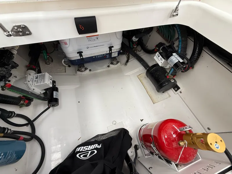 Slide: The Image of The engine room of a 2026 Pursuit OS 325 Offshore shows engines and wiring. - 39