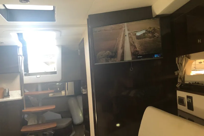 Slide: The Image of Interior of 2018 Sea Ray Sundancer 350 Coupe with TV and seating area. - 15