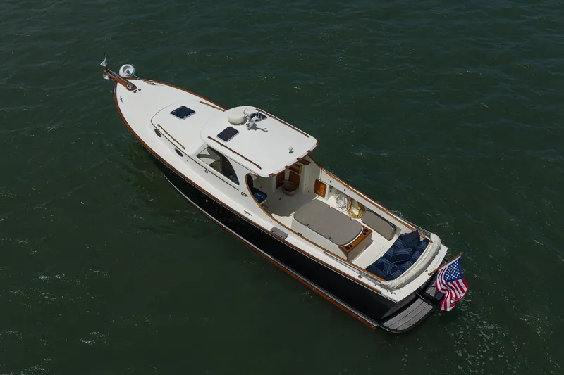 Slide: The Image of 2000 Hinckley Picnic Boat 36 Classic cruising on open water, aerial view. - 7