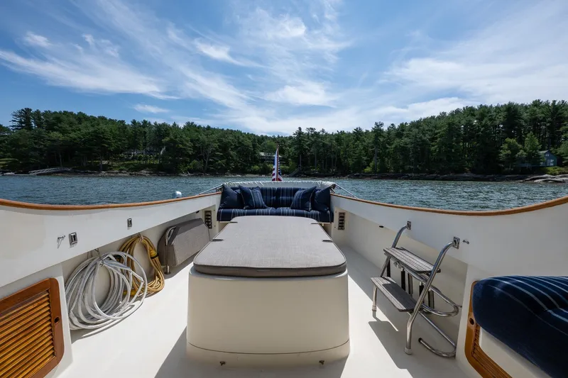 Slide: The Image of Hinckley Picnic Boat 36 Classic, 2000 model, with scenic water and forest backdrop. - 14
