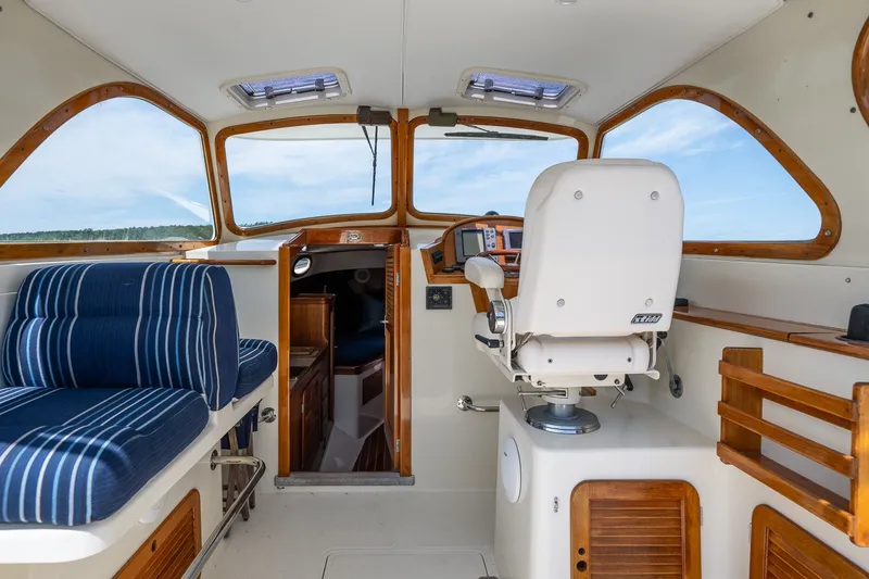 Slide: The Image of Interior of 2000 Hinckley Picnic Boat 36 Classic with helm and seating area. - 16