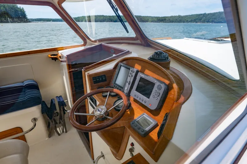 Slide: The Image of Helm of 2000 Hinckley Picnic Boat 36 Classic with navigation instruments and wooden steering wheel. - 22