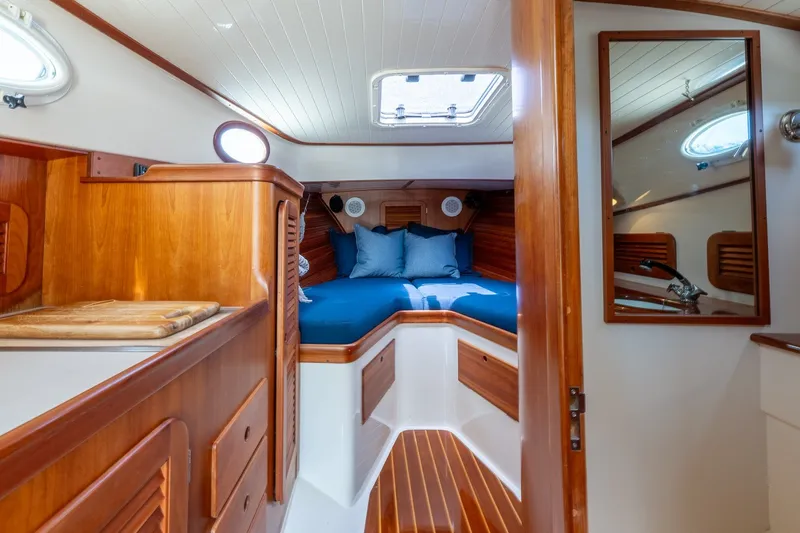 Slide: The Image of Interior of 2000 Hinckley Picnic Boat 36 Classic with wooden finish and cozy cabin. - 24
