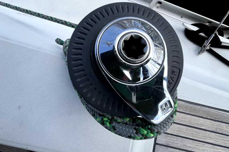 Slide: The Image of Winch on 2006 Beneteau Oceanis 393 sailboat deck with green and black rope. - 74
