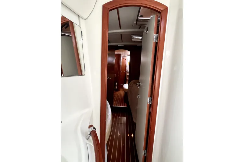 Slide: The Image of Interior view of 2006 Beneteau Oceanis 393 sailboat, featuring wooden doors and flooring. - 37