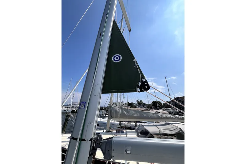 Slide: The Image of Sailboat mast and sail detail on 2006 Beneteau Oceanis 393 under clear blue sky. - 78