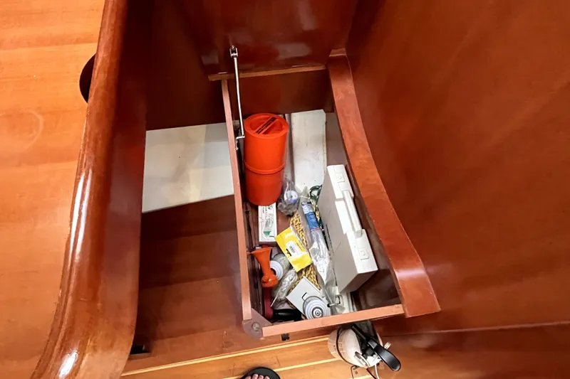 Slide: The Image of Storage compartment in a 2006 Beneteau Oceanis 393 yacht, containing various nautical items. - 34