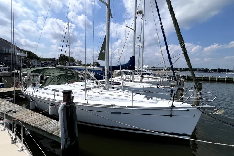 The Image of 2006 Beneteau Oceanis 393 sailboat docked at marina under blue sky. - 0