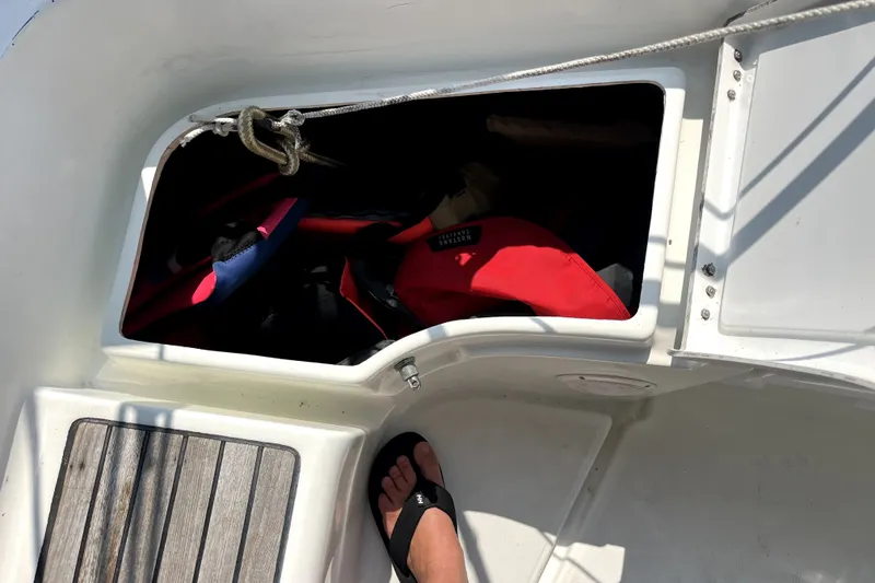 Slide: The Image of Storage compartment on 2006 Beneteau Oceanis 393 sailboat, containing life jackets and gear. - 70