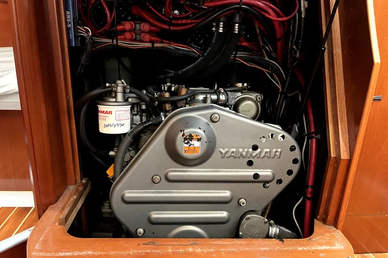 Slide: The Image of Engine compartment of a 2006 Beneteau Oceanis 393 sailboat, featuring a Yanmar engine. - 46