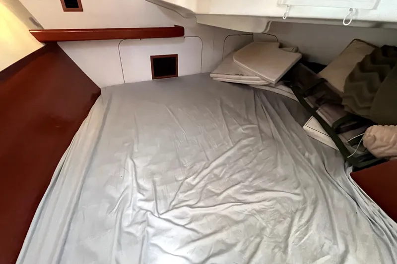 Slide: The Image of Interior cabin of 2006 Beneteau Oceanis 393 sailboat with bed and cushions. - 31