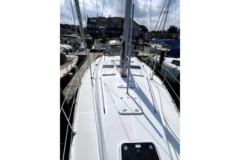 Slide: The Image of 2006 Beneteau Oceanis 393 sailboat docked at marina, showcasing deck and rigging. - 69
