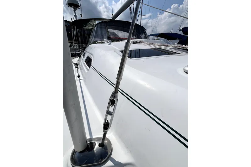 Slide: The Image of 2006 Beneteau Oceanis 393 sailboat deck with rigging, under a partly cloudy sky. - 68