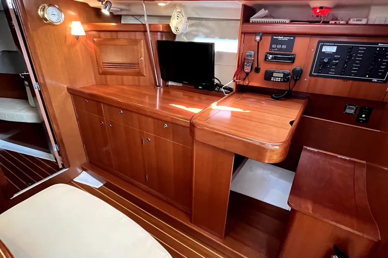 Slide: The Image of Interior of 2006 Beneteau Oceanis 393 yacht with wooden cabinetry and navigation equipment. - 13