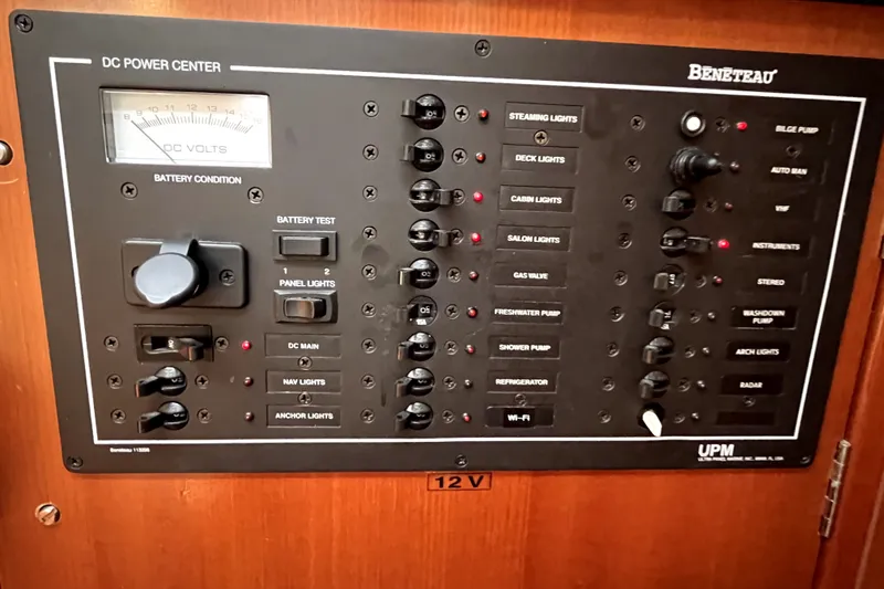 Slide: The Image of Electrical control panel of a 2006 Beneteau Oceanis 393 sailboat, featuring various switches and indicators. - 41