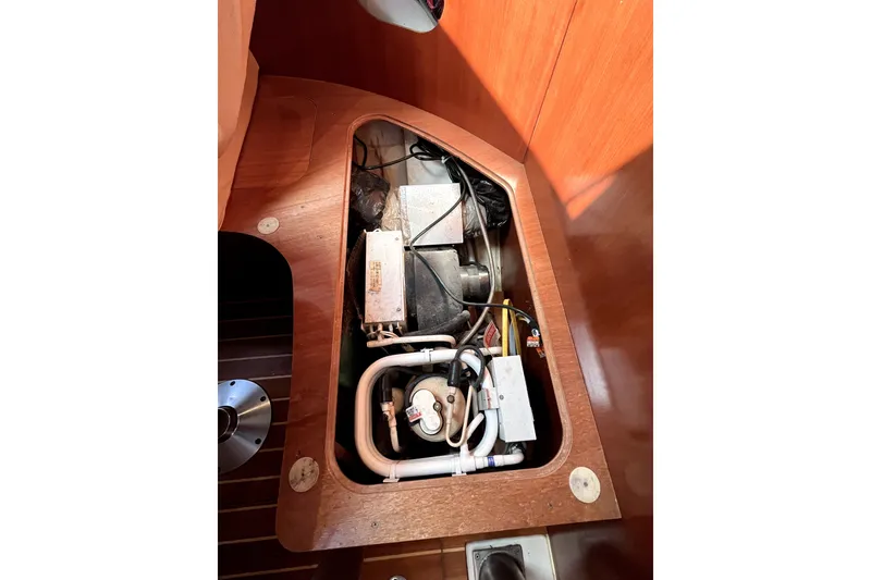 Slide: The Image of Engine compartment of a 2006 Beneteau Oceanis 393 sailboat, showcasing mechanical components. - 28