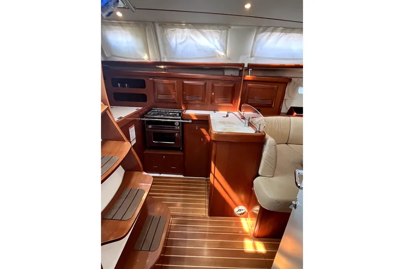 Slide: The Image of Interior of 2006 Beneteau Oceanis 393 yacht with wooden cabinetry and compact kitchen. - 18
