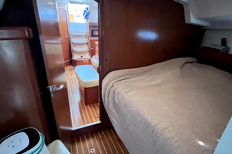Slide: The Image of Interior of 2006 Beneteau Oceanis 393 yacht, featuring cozy cabin and wooden flooring. - 42
